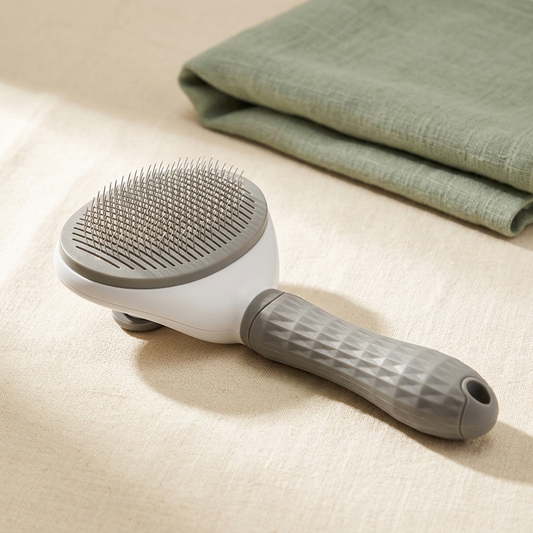 PetRoost ergonomic pet grooming brush — three-quarter angle